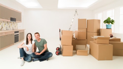 Unpacking household items into rooms after a move in Dulwich